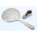 An Art Deco silver bevelled hand mirror together with a 20th Century electroplate finished pin