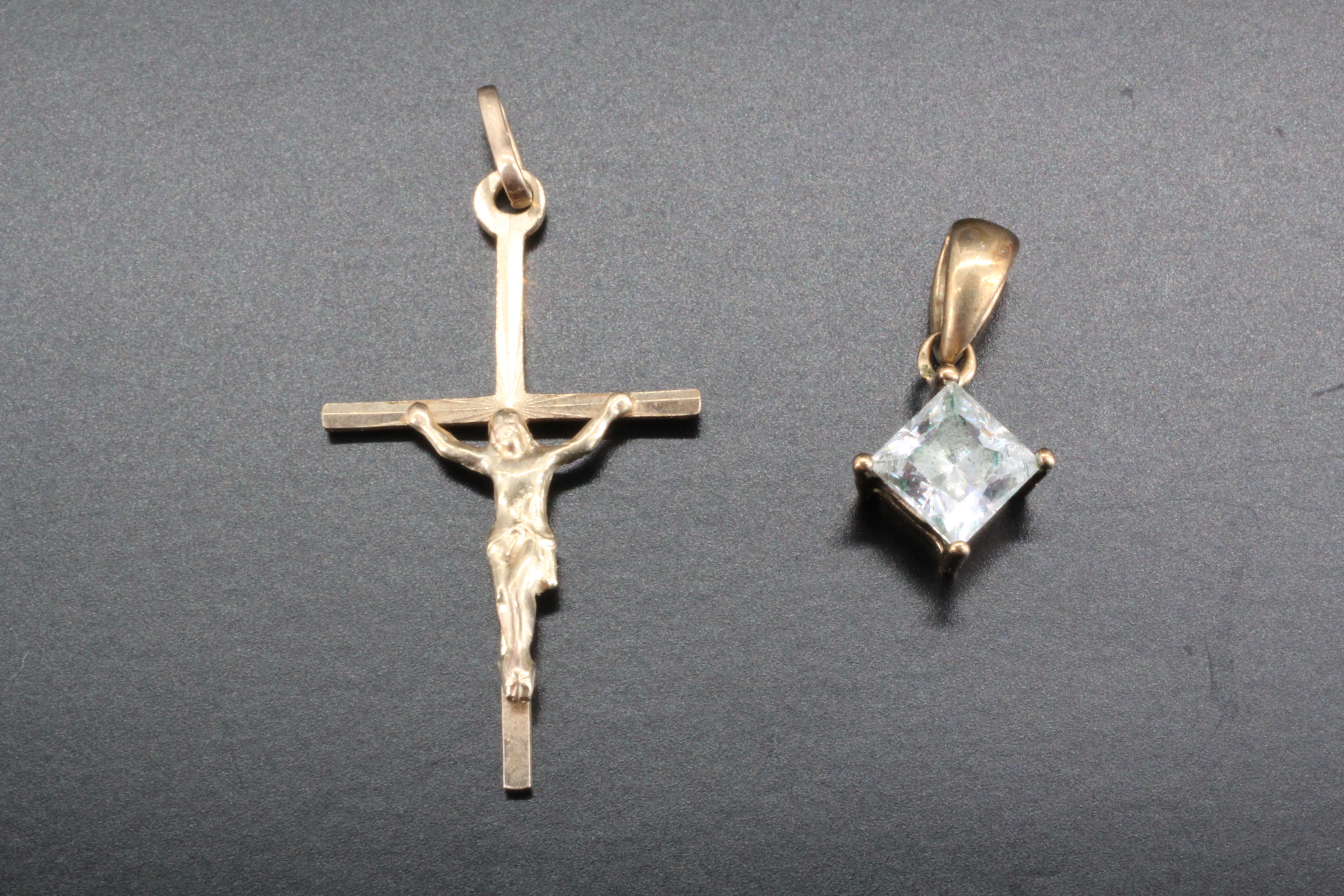 A 9 ct gold crucifix, late 20th century, marked "375", together with a low carat yellow metal