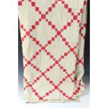 A geometric patchwork quilt formed with red and white panels, machine and hand sewn, lined, 234 x
