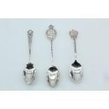 Three early 20th Century silver golf prize tea spoons