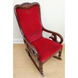 A Victorian mahogany open arm rocking chair with carved crest rail (a/f)