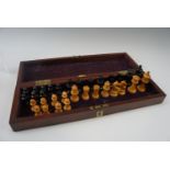 A vintage Staunton style chess set, in a mahogany case, king 7 cm