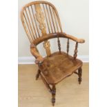 A quality reproduction elm seated Windsor armchair together with matching smaller chair and