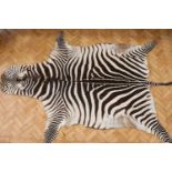 A zebra skin rug, 290 x 200 cm
