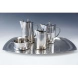 A four-piece Swedish stainless steel tea set together with a tray