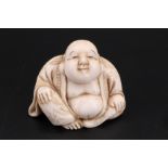 A Japanese ivory netsuke of Hotei, 3 cm