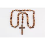 An olive wood rosary, turned wooden beads and crucifix with a white metal corpus, latter 20th