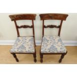 A pair of Regency mahogany dining chairs, having veneered crest and carved cross rails raised on