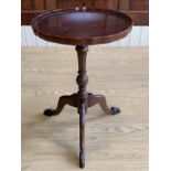 A reproduction Georgian mahogany tripod wine table, having a Chippendale style top with pie-crust