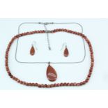 A gold stone bead necklace, (beads 6 mm, 51 cm), together with a teardrop shaped pendant, neck chain
