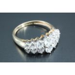 A 14 carat gold dress ring, set with a double row of graduated round white stones on a gallery