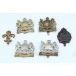 A group of Manchester Regiment cap badges