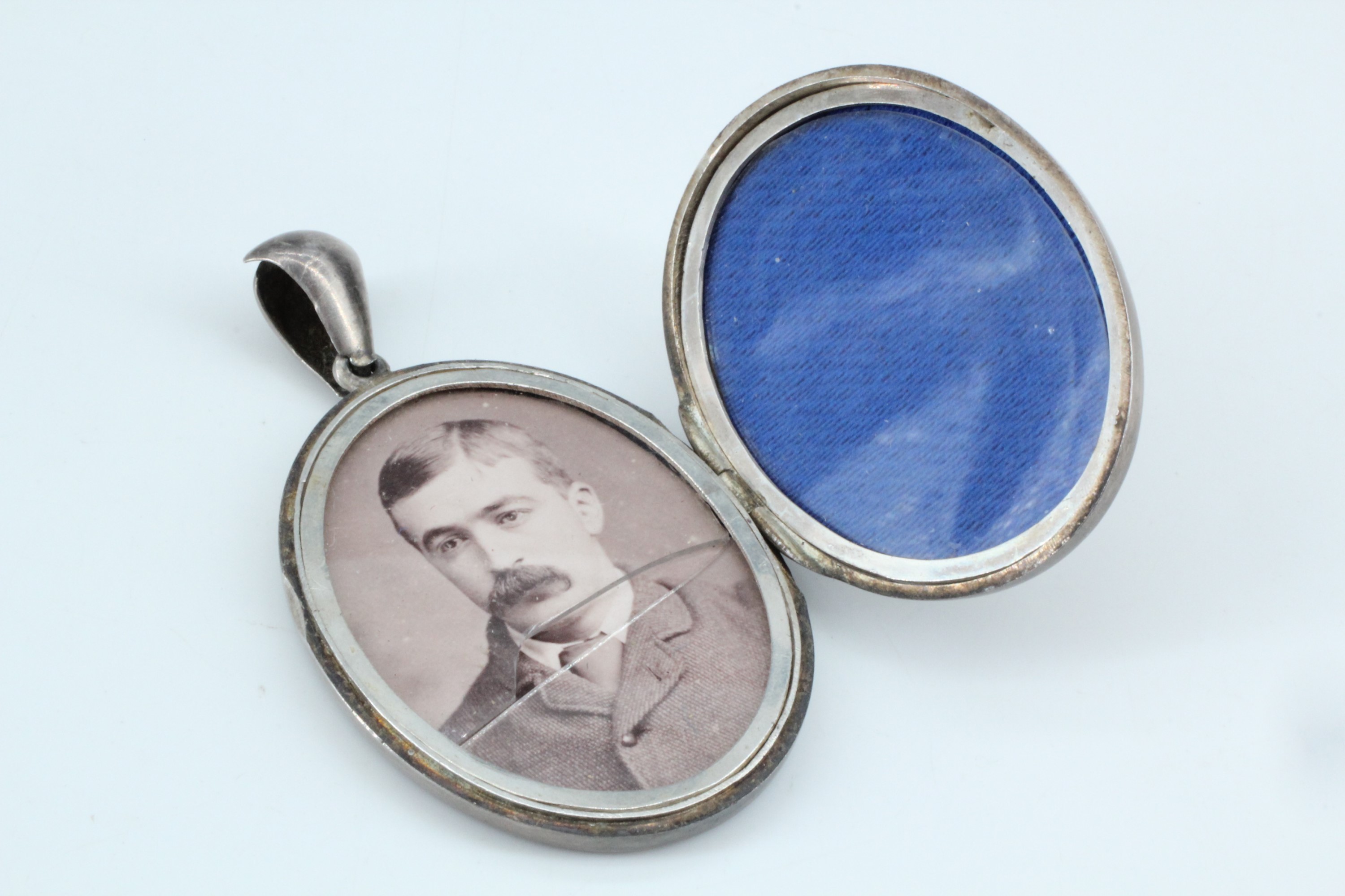 A Victorian Aesthetic Movement influenced white metal double pendant locket, its face shallow relief - Image 3 of 3