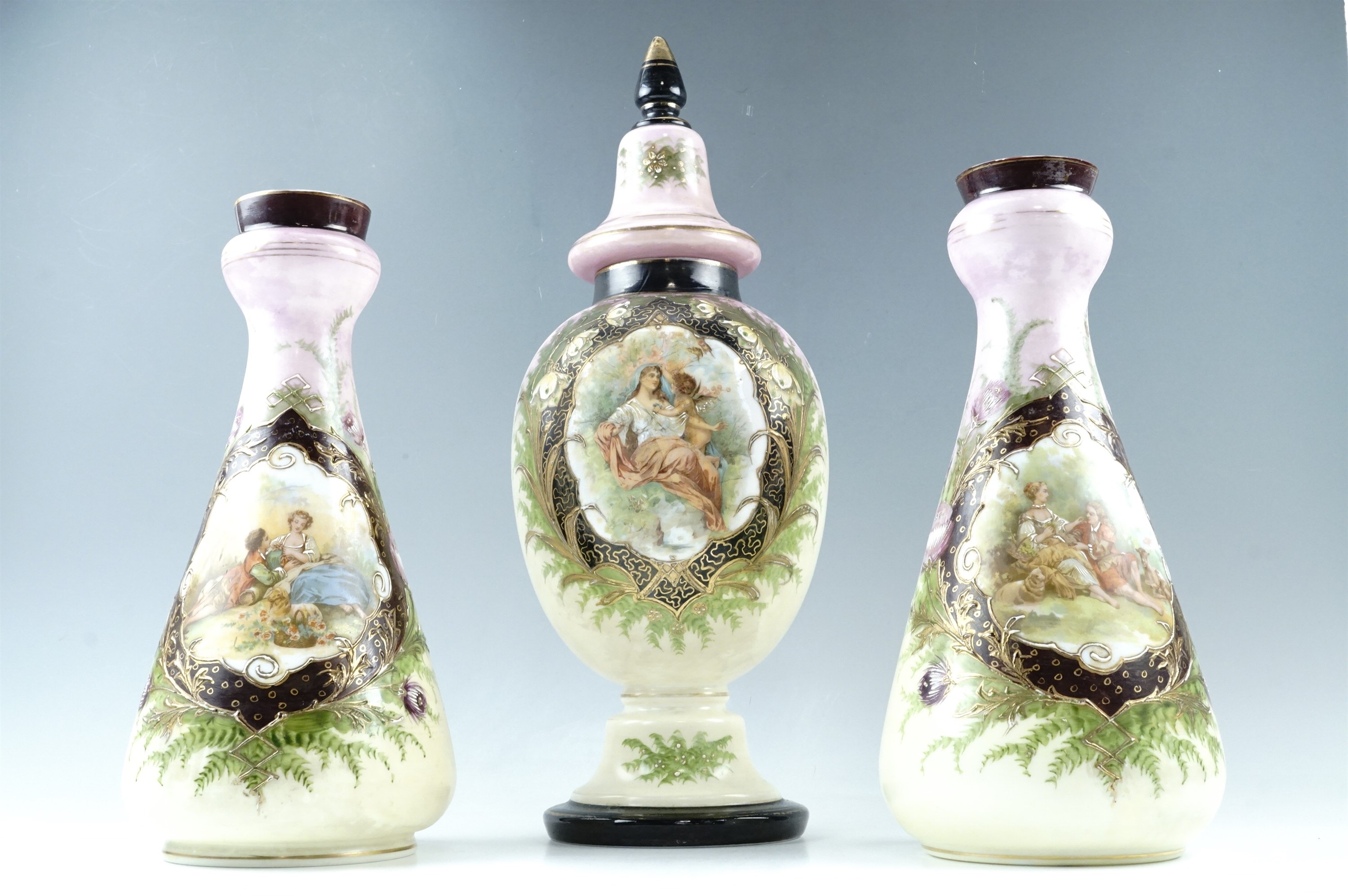 A large Victorian enamelled glass lidded jar, 50 cm, together with two enamelled glass vases, 37 cm