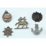 Five Second World War plastic cap badges