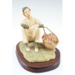 An early limited edition Border Fine Art figurine of a clown sat beside a large basket of