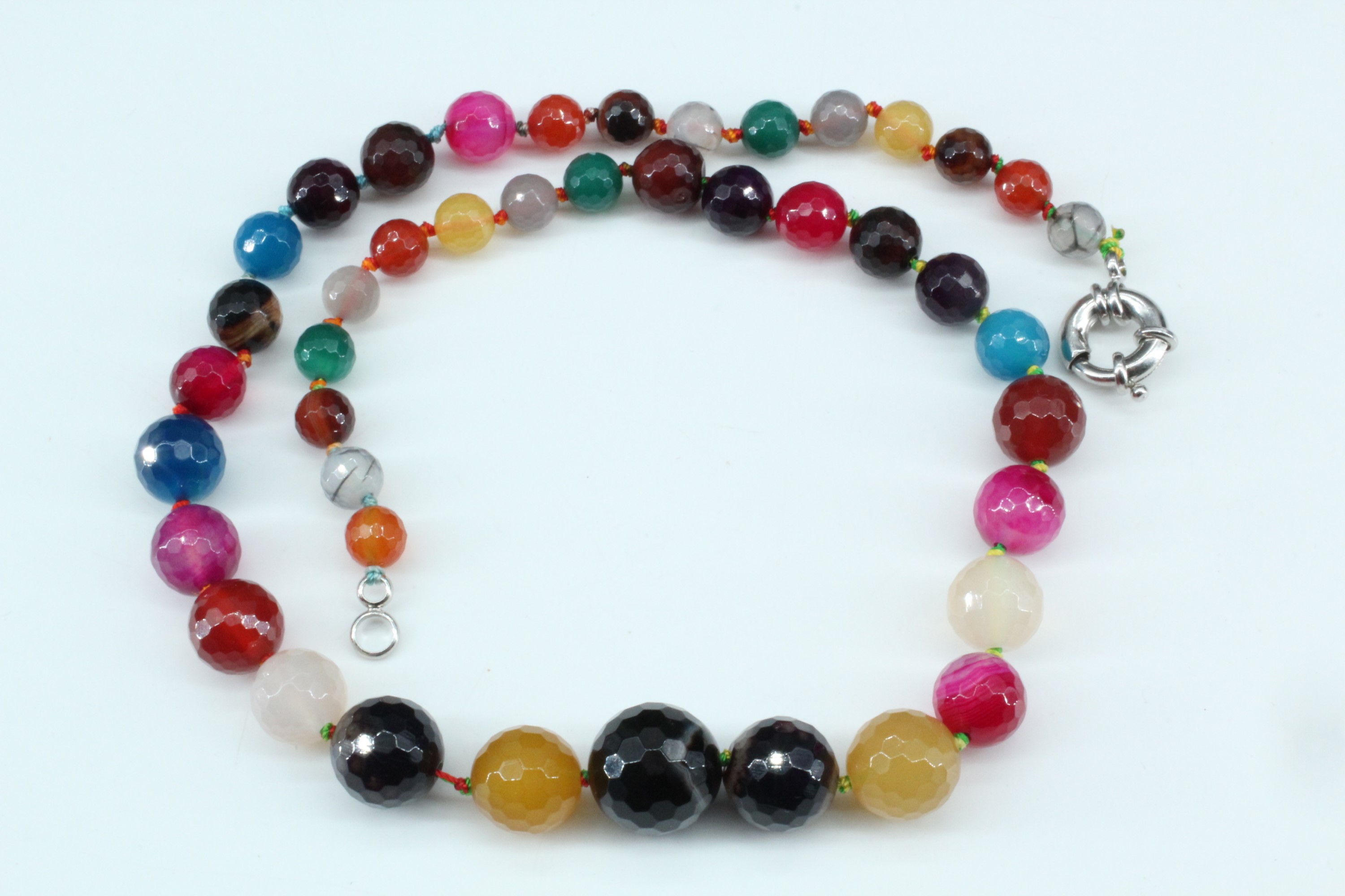 A necklace of graded and faceted semi-precious gem stone beads, largest 16 mm, 52 cm