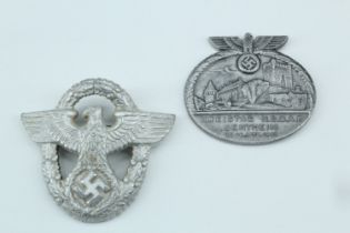 A German Third Reich police cap badge, together with a day badge