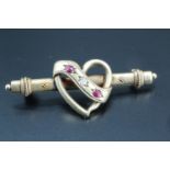 A Victorian diamond and pink stone set romantic bar brooch, the stones gypsy set on a scroll
