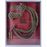 A framed display of Life Guards shoulder cords, an aiguillette etc