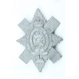 A Second World War Black Watch plastic cap badge