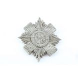 A Second World War Scots Guards plastic cap badge