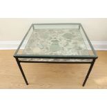 A late 20th Century glass topped coffee table incorporating a shelf set with shards of Chinese