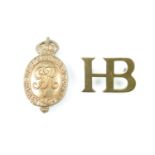 A Household Battalion cap badge and brass shoulder title