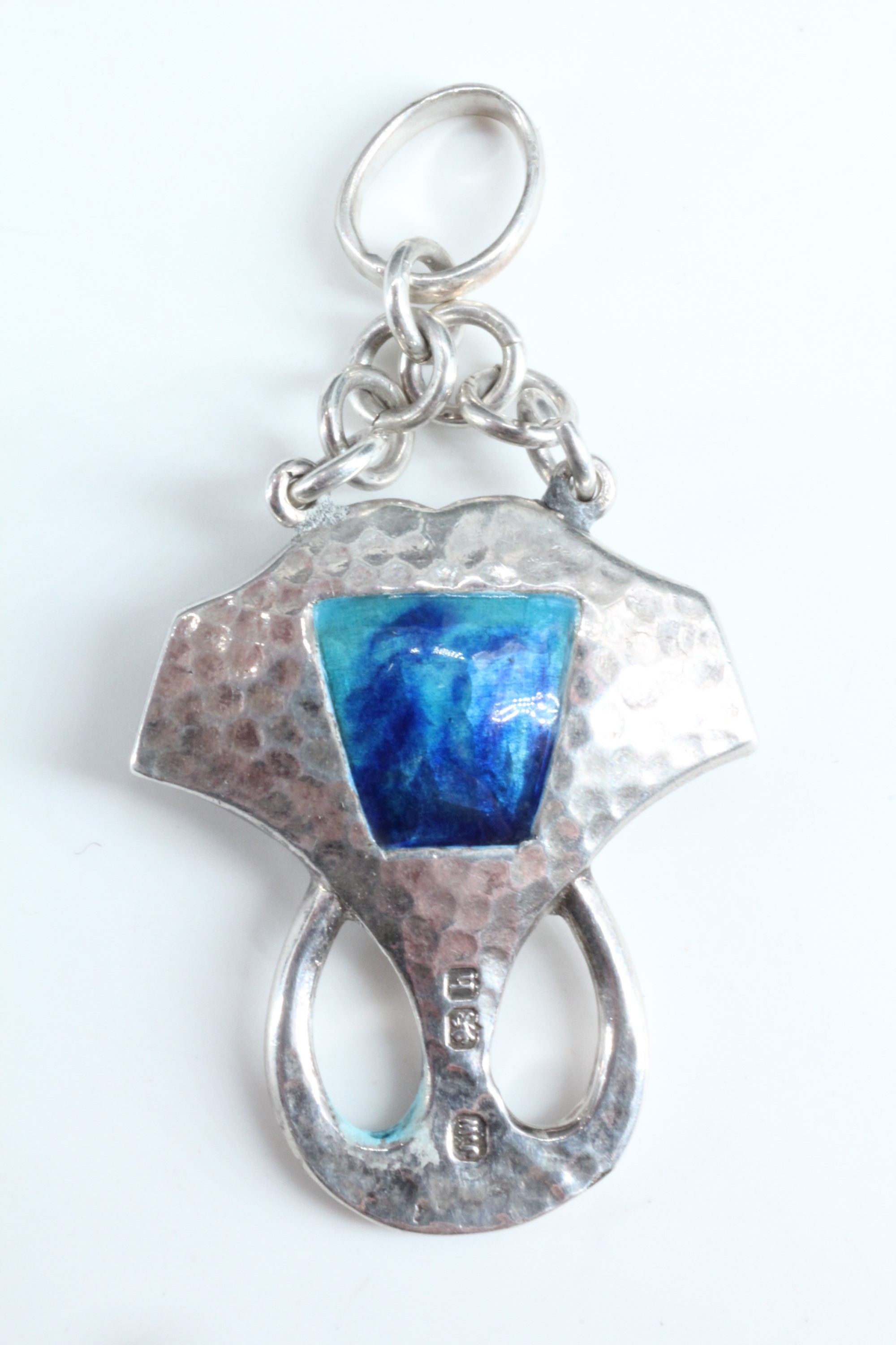 An Edwardian Arts and Crafts enamelled silver pendant, of geometric form, planished and centred by - Image 2 of 2