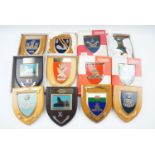 A quantity of military shield-shaped plaques, many in original cartons