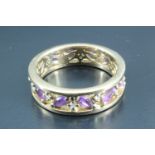 An unusual amethyst and diamond eternity ring, having navette shaped amethysts, approximately 2 x