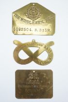 Three various British army other ranks' brass duty plates including a Staffordshire Regiment knot-