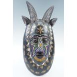 An African carved mask, 53 cm