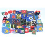 A large quantity of British army period and reproduction cloth insignia