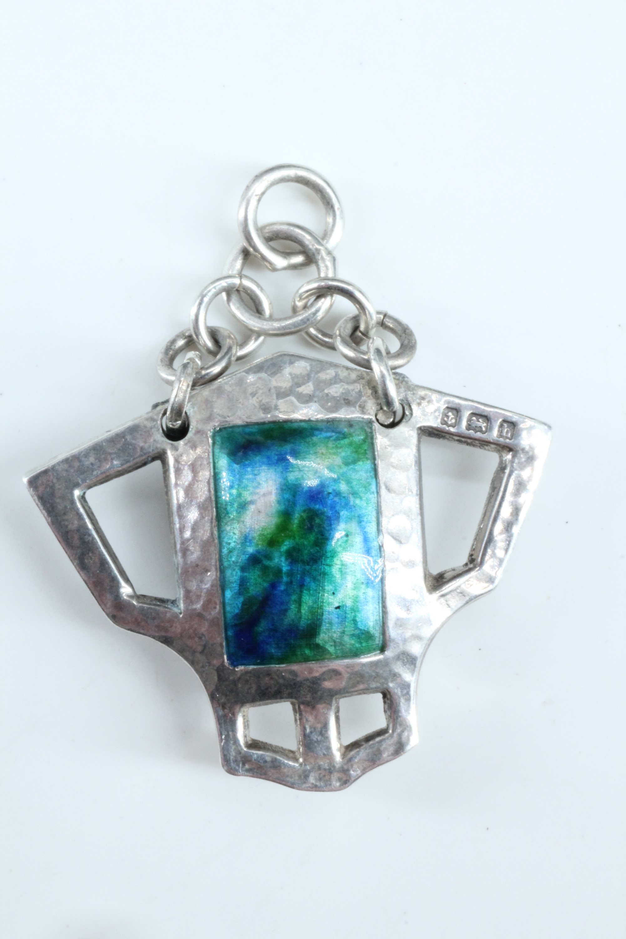 An Edwardian Arts and Crafts enamelled silver pendant, of geometric form, planished and centred by - Image 2 of 2