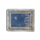 A silver photograph frame, of shallow cushion-moulded form and border by ribbon-tied reeds, 13 cm