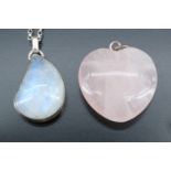A contemporary moonstone pendant, the asymmetric teardrop shaped cabochon collet-set in white metal,