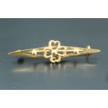 A late 19th / early 20th Century high carat yellow metal bar brooch, of lenticular form and faced by