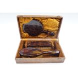 A 1950s cased faux tortoise shell dressing table set