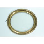 An Edwardian oval brass photograph frame, 19 x 16 cm seen,