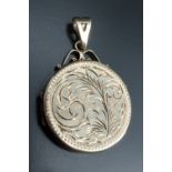 An engraved round locket pendant, having bright cut floral decoration front and verso, the bail on