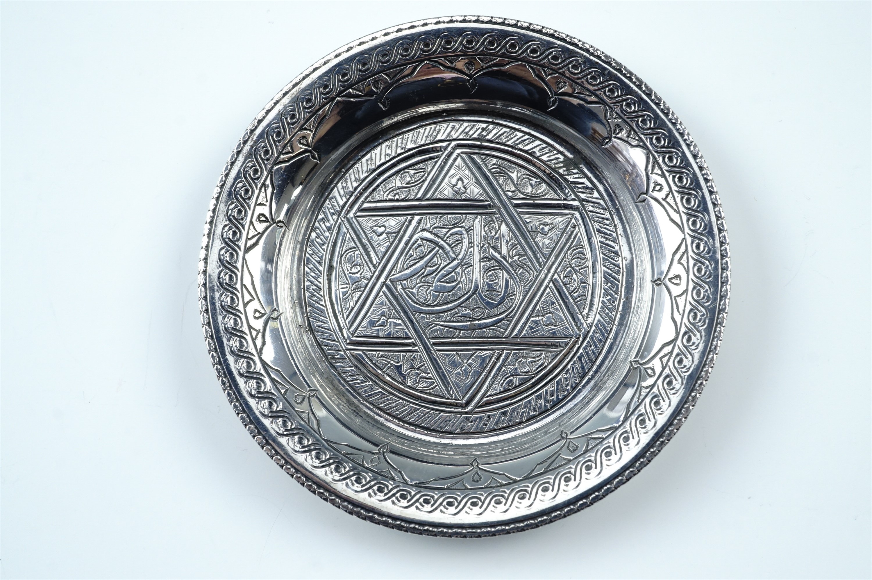 An Egyptian engraved white metal pin dish, tested as silver, struck marks, circa 1942-3, 7.5 cm - Image 2 of 4