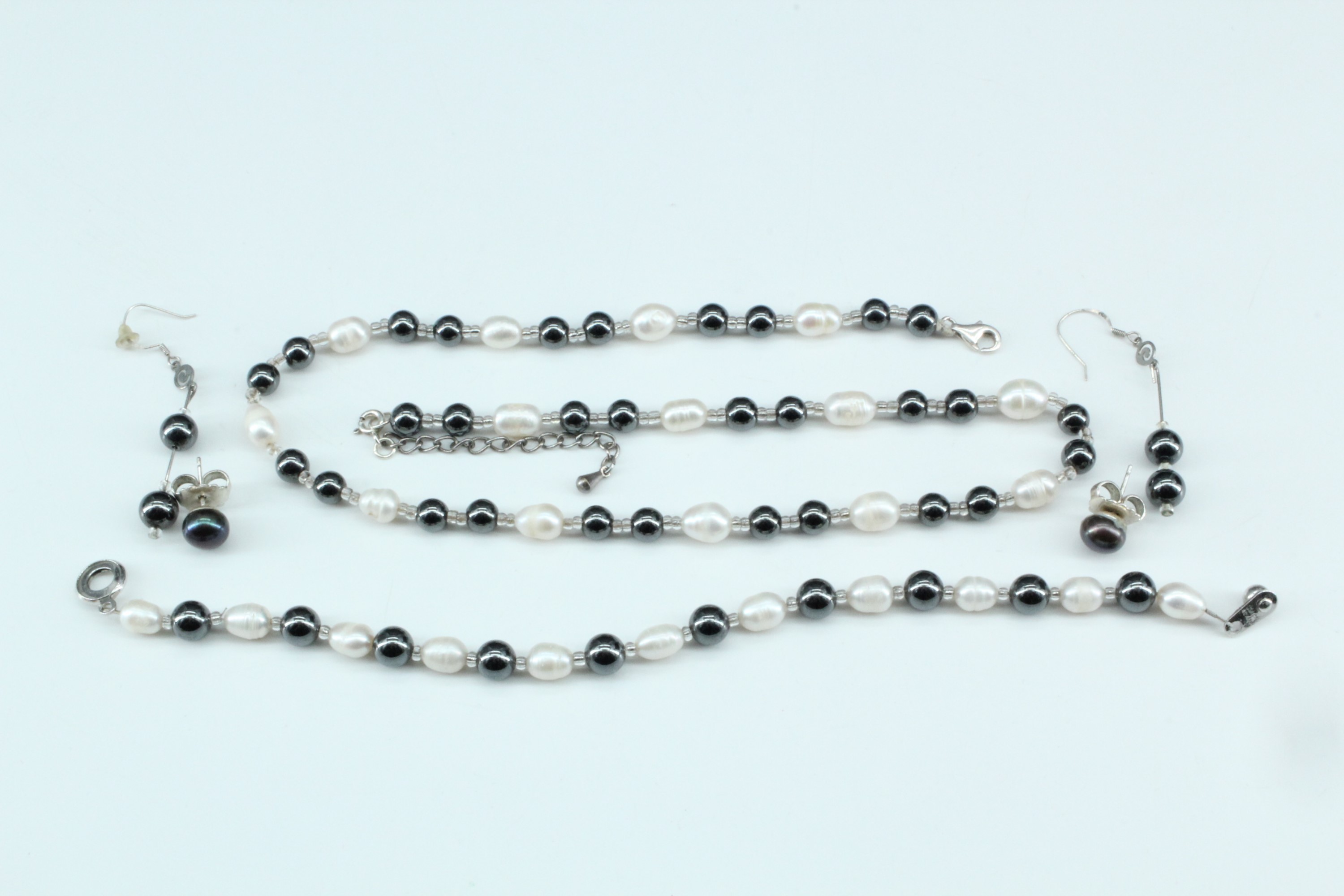 A contemporary bracelet and necklace of fresh water pearls and haematite beads, together with two