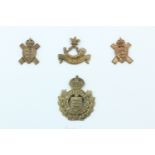A group of Channel Islands military cap badges