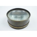 A Victorian brass magic lantern lens, 10 cm diameter
