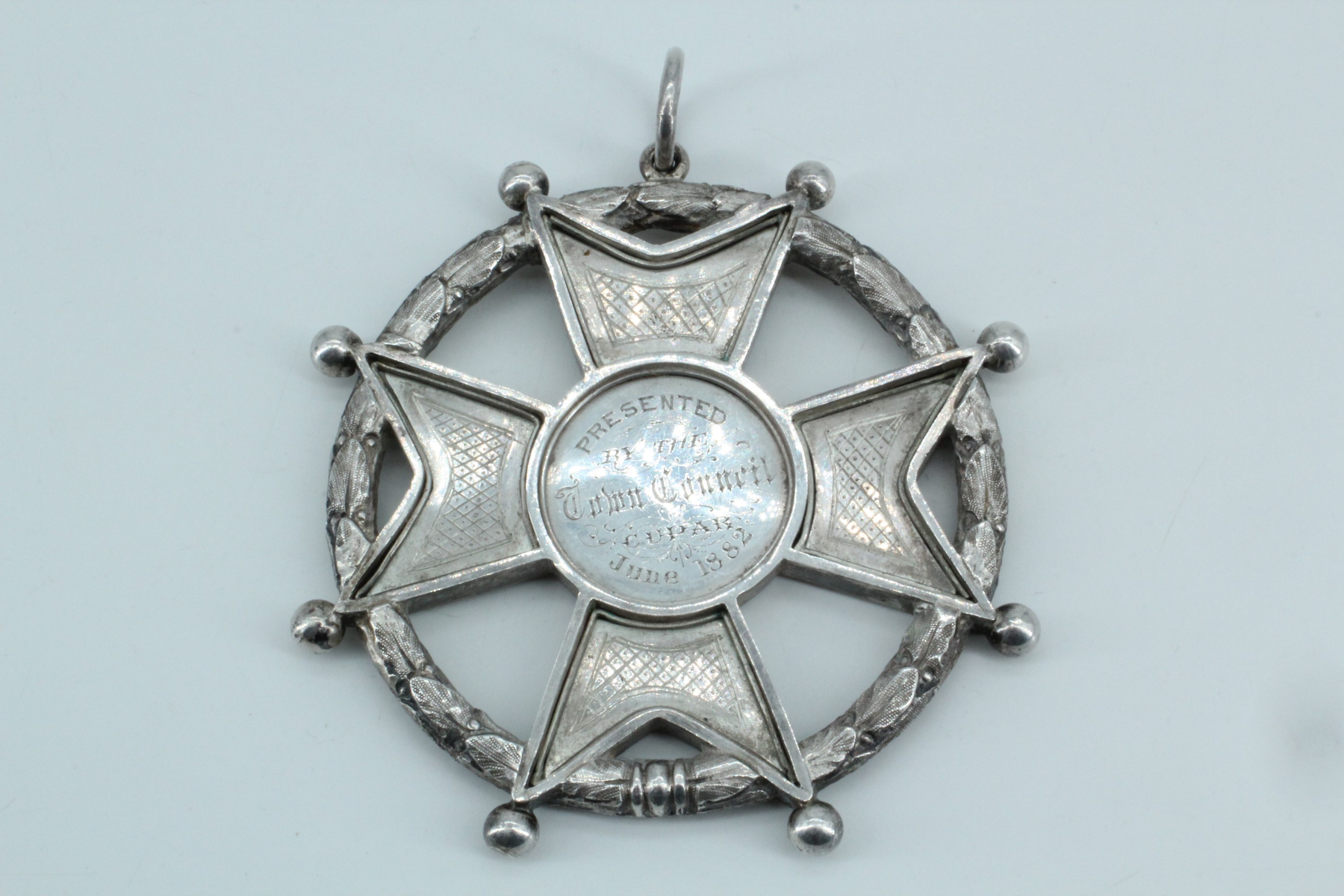 An uncommonly large Victorian white metal prize medallion, in the form of a Maltese cross within a