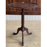 A reproduction Georgian mahogany tripod wine or lamp table, having a spirally reeded column an