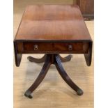 A Regency mahogany Pembroke table, having a rounded oblong top, on a heavy turned column and