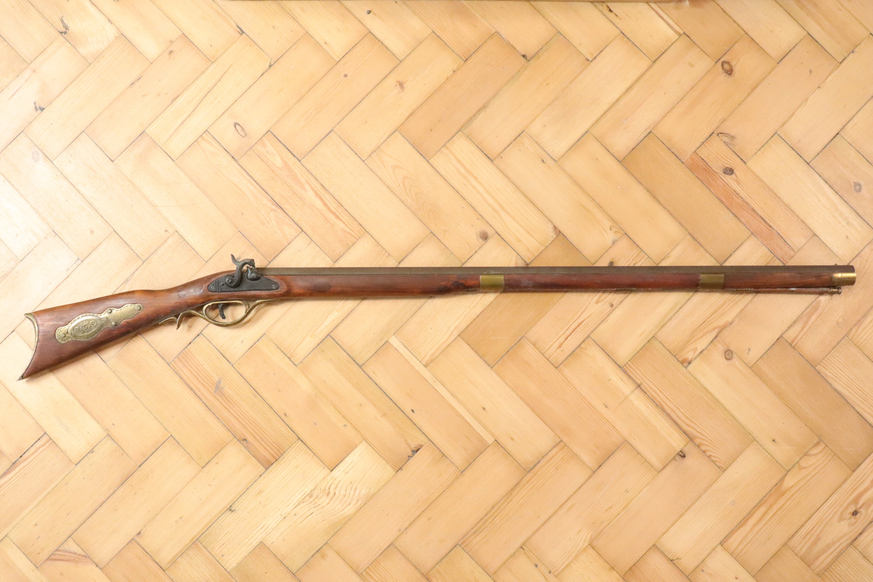 A decorative reproduction Pennsylvania percussion long gun, (non-firing)