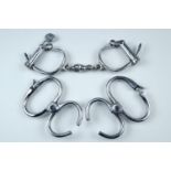 Vintage Hiatt handcuffs together with two sets of Hiatt wrist restraints